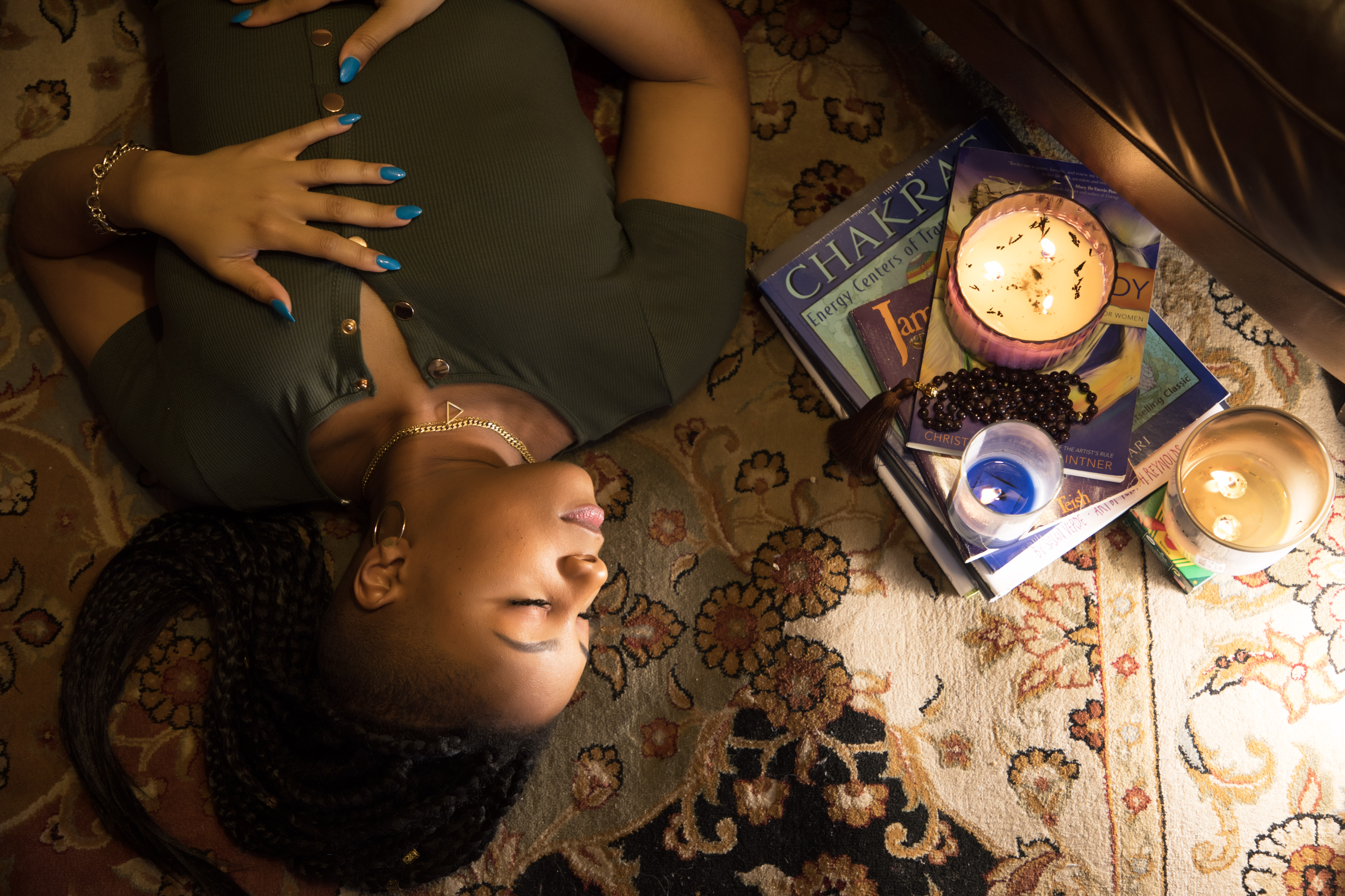 Ally seated in peaceful mindfulness, surrounded by candles and books