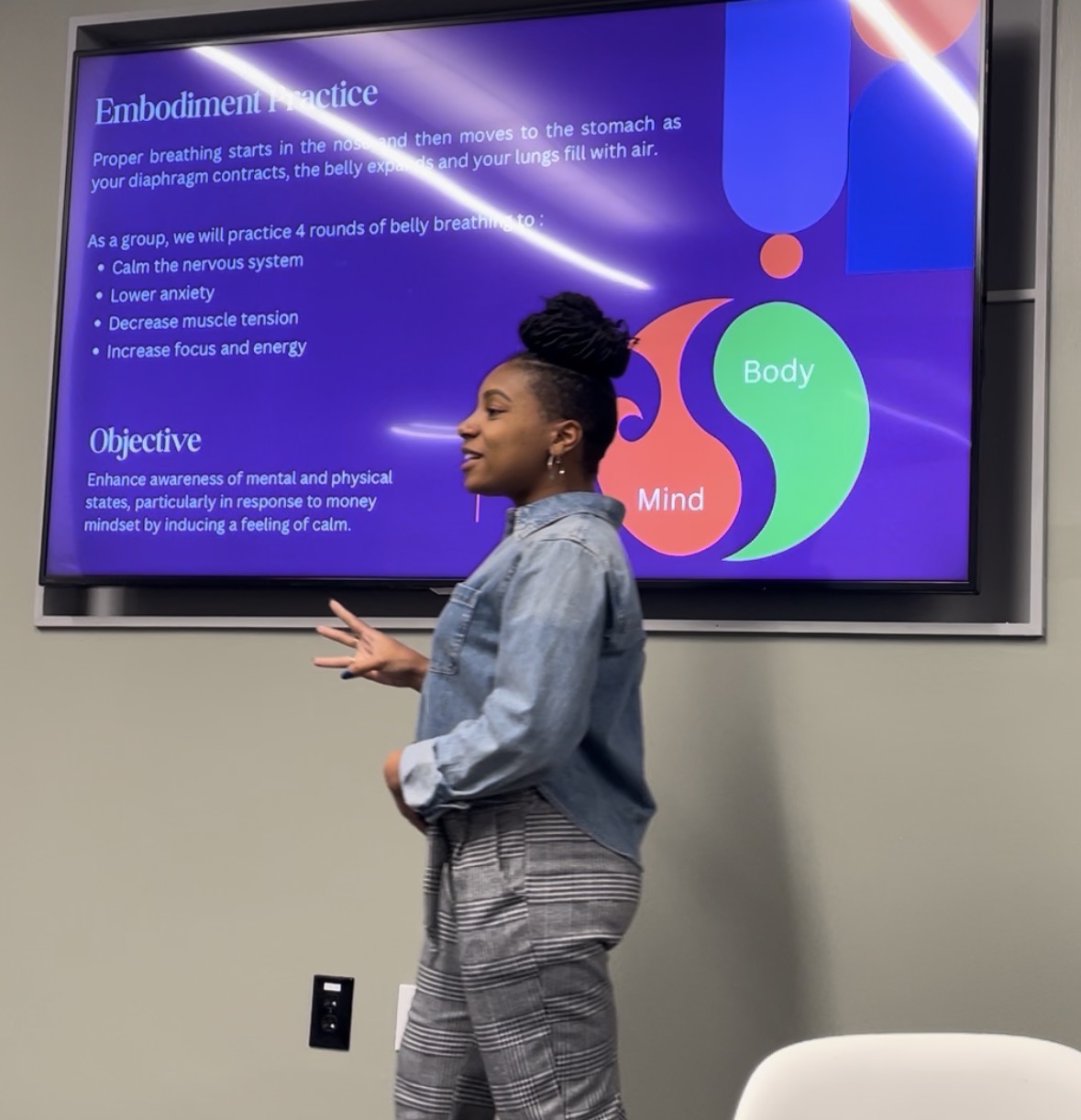 Ally presenting at a wellness seminar for a professional audience