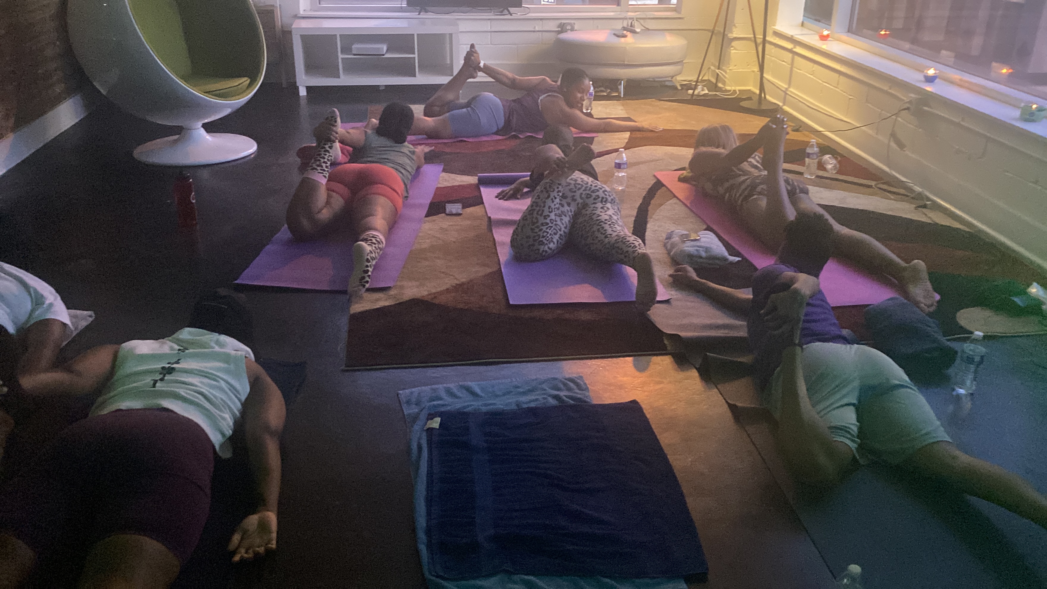 Ally leading a yoga session with calm, focused instruction